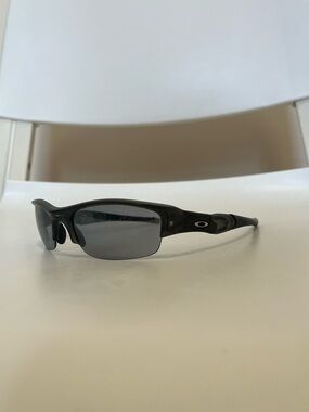 Oakley Flak Jacket XLJ sunglasses featuring a matte black frame and black lenses